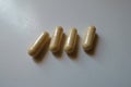 Close shot of 4 beige capsules of milk thistle extract