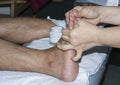 Close shot of bodily parts massaging foot scene