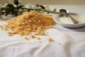 close shot of bread crumbs scattered on a white tablecloth