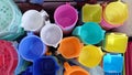 Close shot of collection of mugs,household articles buckets mugs multicolored in supermarket