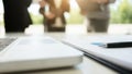 Close-shot of a computer displaying and financial data, three business executives standing on the background Royalty Free Stock Photo