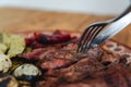 Close shot of cutlery cutting a piece of meat. Traditional Mexican dish with meat. Royalty Free Stock Photo