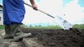 Close shot of farmer shovel the soil around