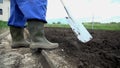 Close shot of farmer tunring around the soil to make it fresh on the surfacace