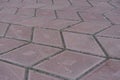 Close shot of grayish pink diamond-shaped concrete pavement with geometric pattern Royalty Free Stock Photo