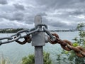 Close shot of a half new half rusty iron railing with cloudy sky background.