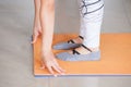 Close shot hands and feet of woman practice yoga indoor on mat