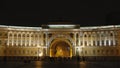 Close shot of Illuminated arch of General Staff and people in the night