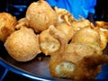 Close shot of indian street food made of the paste of gram and filled with bananas, chillies and eggs called Pakauri in Hindi Royalty Free Stock Photo