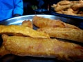 Close shot of indian street food made of the paste of gram and filled with bananas, chillies and eggs called Pakauri in Hindi Royalty Free Stock Photo