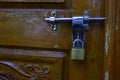 Close shot of locked padlock isolated on wooden door Royalty Free Stock Photo