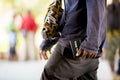 Close shot of a male holding a bible walking in the street with a blurred background Royalty Free Stock Photo