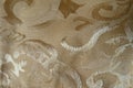 Close shot of old-fashioned beige damask jacquard fabric