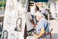 Close shot of a person drawing caricature with a blurred background at daytime