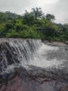 A close shot photo of a sawatsada waterfall in the middle of a forest in chiplun.