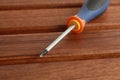 Close shot of a screwdriver tipped star, orange blue and black