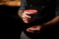 Close shot of tattooed bartender holding an alcohol cocktail Royalty Free Stock Photo