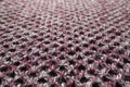 Close shot of pink, grey and white woolen fabric with diamonds pattern Royalty Free Stock Photo