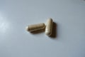 Close shot of two beige capsules of Saccharomyces boulardii probiotic