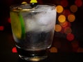 A close shot of a vodka and tonic drink with a slice of lime