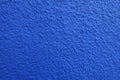 Close shot of wall with coarse blue roughcast finish