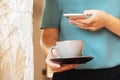 Close shot of woman hands holding mobile phone take photo of cup of coffee foam art in cafe. Royalty Free Stock Photo