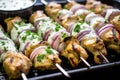 close shot of yogurt marinated kebabs on a tray