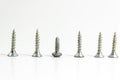 Close side shoot of multiple screws on white blurry background