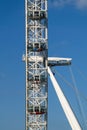 Close side view of London Eye against a blue sky