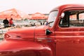 Close Side View Of Red International Harvester R-series Truck With Small American Flag Parked In Street.