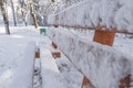 Close side view of wooden bench on snow natural cold day forest