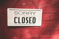 Close sign hanging on red stone wall texture background Royalty Free Stock Photo