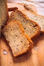 Close slice of fresh bread with poppy seeds on a wooden background