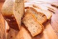 Close slice of fresh bread with poppy seeds on a wooden background