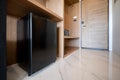 Close small refrigerator under the wood counter and in front of enter door delux room at resort and hotel