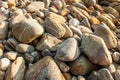 Close of stone beach at sunset, beautiful shape and patterns of stones and pebbles on natural tropical beach. Lanta Island,