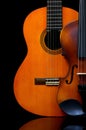 Vintage violin and wooden guitar on dark background