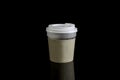 Close take-out coffee with cup holder. Isolated on black background with Reflections Royalty Free Stock Photo