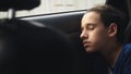 Close. Teenage boy sleeping in the back seat of car