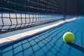 Close of tennis ball on white line near net