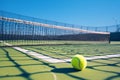 Close of tennis ball on white line near net