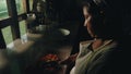 local tribal lady preparing traditional food at her rainforest home