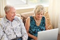 Close to home and to the outside world. a senior couple using a laptop together on the sofa at home. Royalty Free Stock Photo