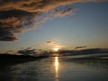 Evening sky with dark rainclouds and fiery sunlight reflections at Findhorn Bay, Scotland Royalty Free Stock Photo