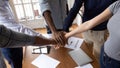 Closeup diverse employees put hands in stack showing support