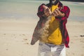 Close u view of unrecognizable caucasian tourist man playing with the sand at the beach durint tropical vacation - adult people Royalty Free Stock Photo