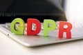 Close up of abbreviation GDPR set on the bottom of laptop standing on white table. Concept of personal data control and protection Royalty Free Stock Photo