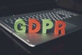 Close up of abbreviation GDPR set on the bottom of laptop standing on white table. Concept of personal data control and protection Royalty Free Stock Photo