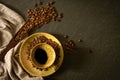 Close-up above of Black hot coffee with milk foam for morning menu in brown ceramic cup with saucer and napkin, coffee beans roast Royalty Free Stock Photo