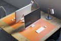 Close up and above view of designer office desk with mock up computer display on wooden desk, rug, lamp and other items. Mock up, Royalty Free Stock Photo